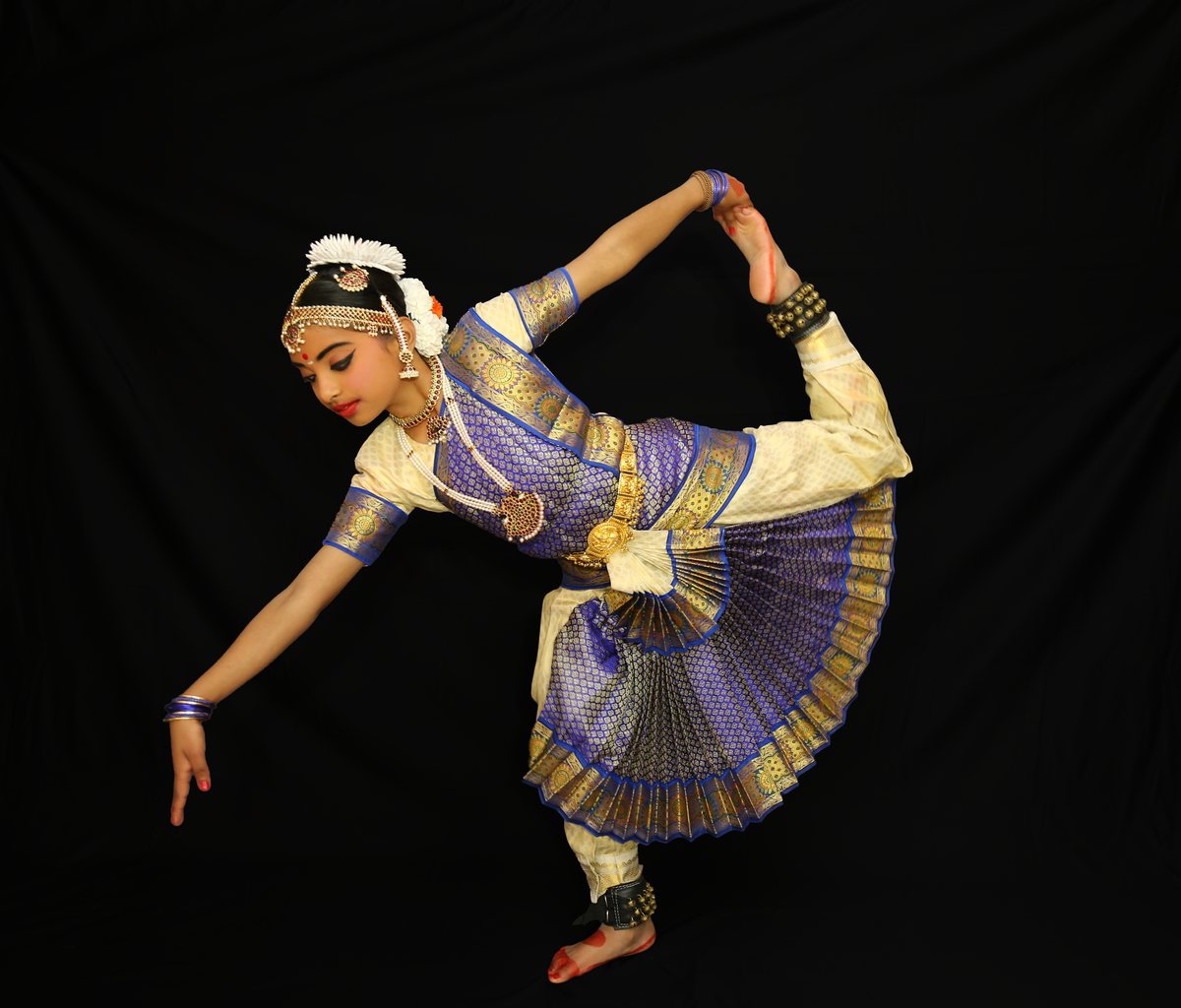 Shriya in a striking pose, foot drawn to her head