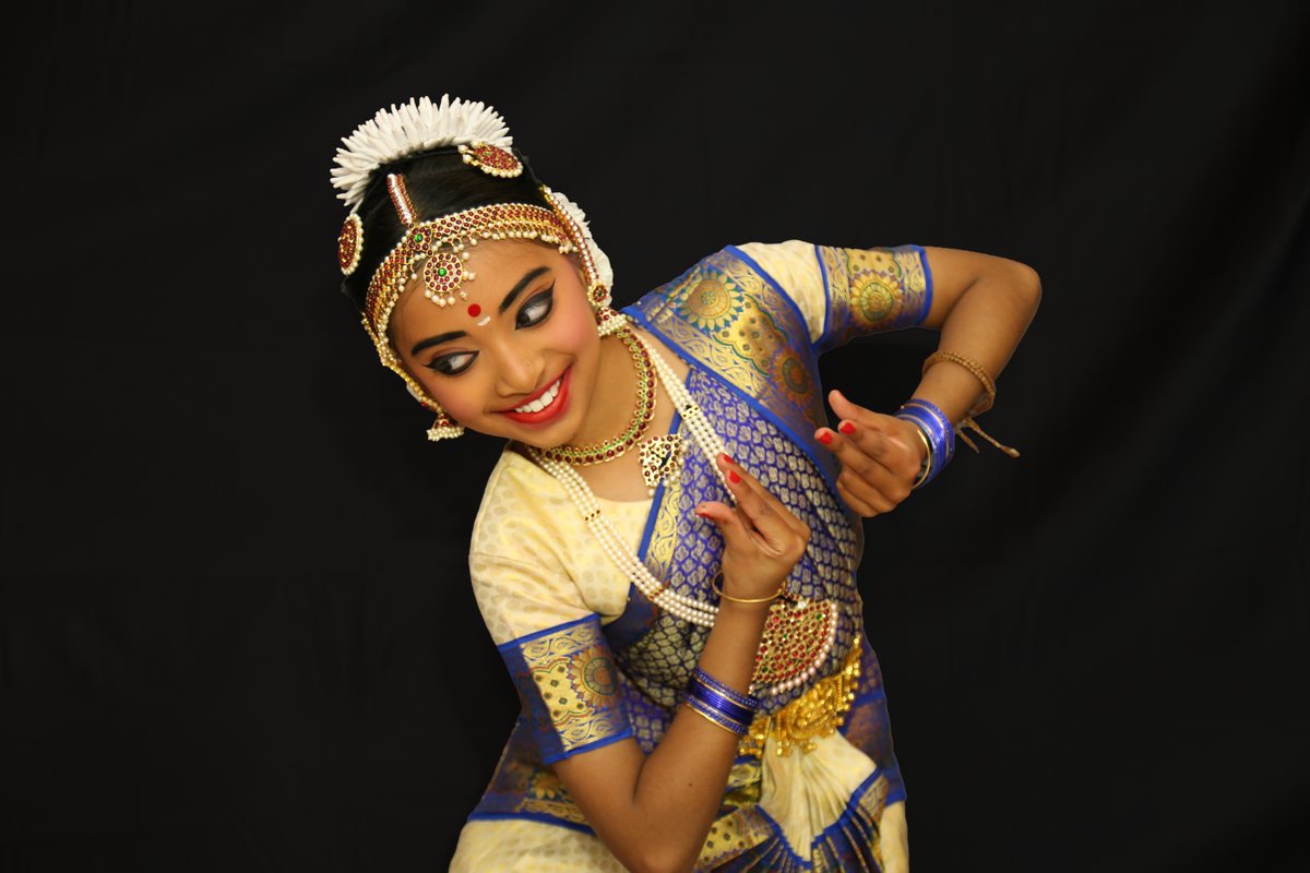 Shriya kneeling in a dance pose