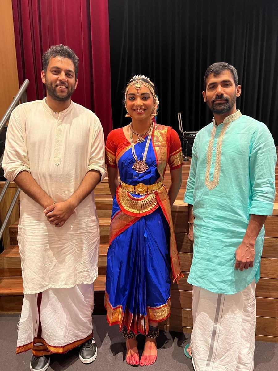 Shriya in blue costume with musicians after a performance