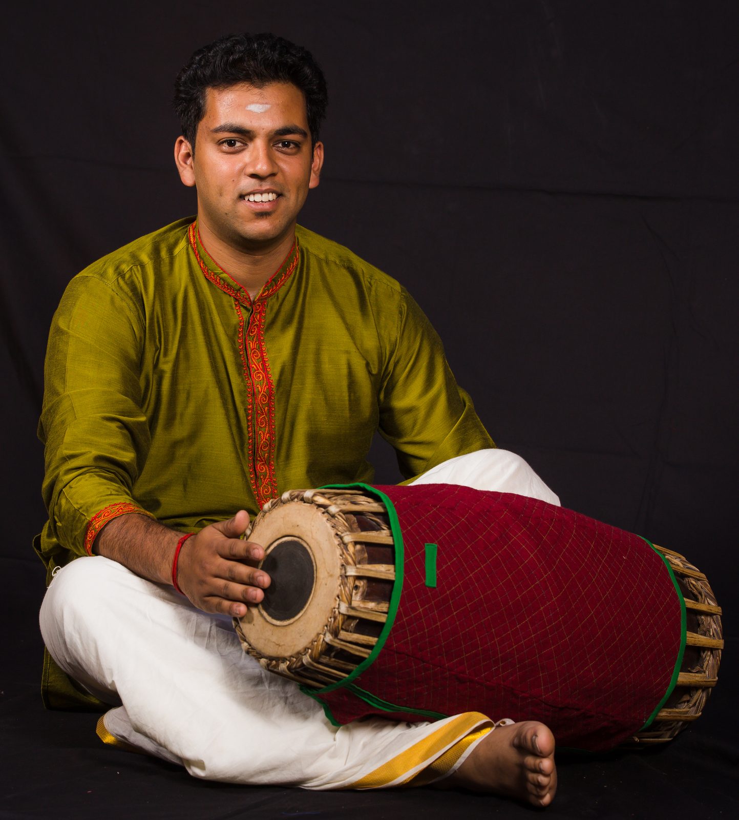 Sri. Satheepan Elankumaran seated at the mridangam